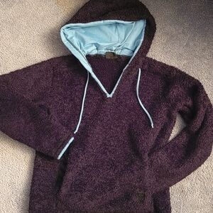 Mountain Hardwear black pullover hoodie with blue trim.